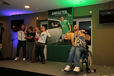 Es ist Graf Fidi während seines Auftritts zu sehen. Im Hintergrund tanzen vier junge Menschen. 
