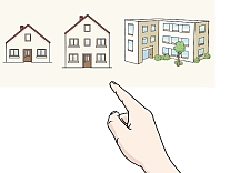 Eine Hand zeigt auf drei Häuser 