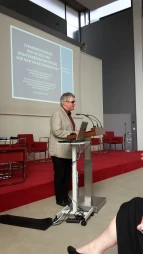 Joachim Steinbrück begrüßt das Publikum vom Rednerpult aus