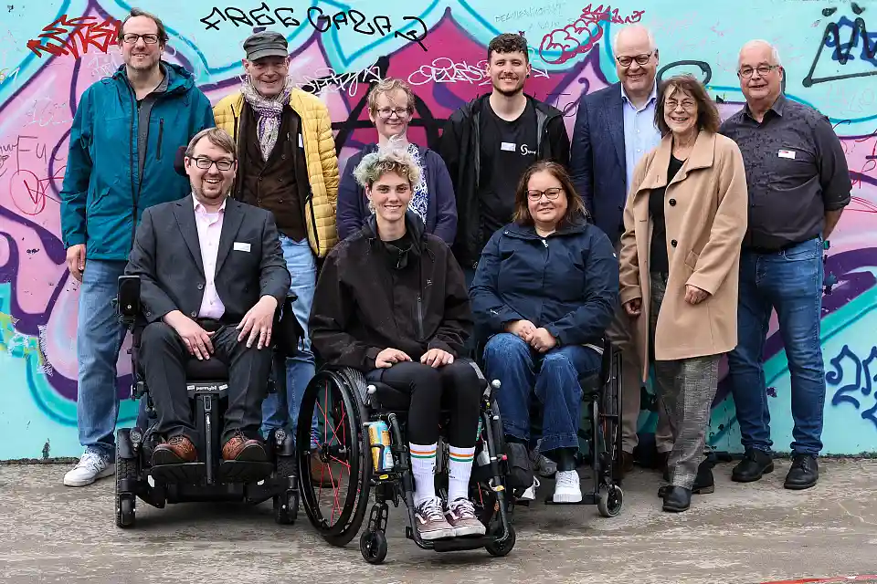 Gruppenbild der Teilnehmenden vor einer Graffiti-Wand