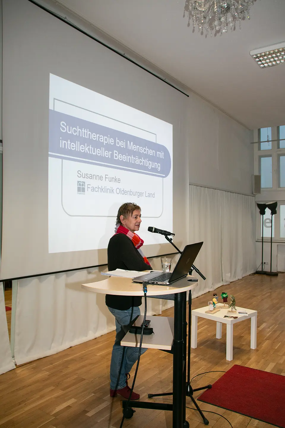 Auf dem Bild sieht man Susanne Funke, Fachklinik Oldenburger Land. Im Hintergrund steht an der Wand der Titel ihres Vortrags "Suchttherapie bei Menschen mit interlektueller Beeintr&auml;chtigung"